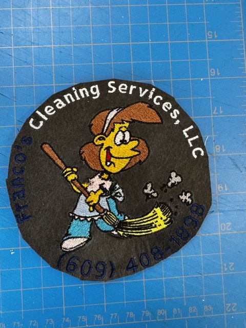Round embroidered patch for Franco's Cleaning Services, LLC with a witch-on-a-broom mascot and phone number stitched around the edge