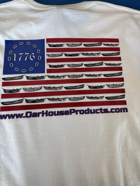 Back of a white tee with a multi-color screen print of a US flag made from rowing boats, '1776' in the star canton, and OarHouseProducts.com beneath