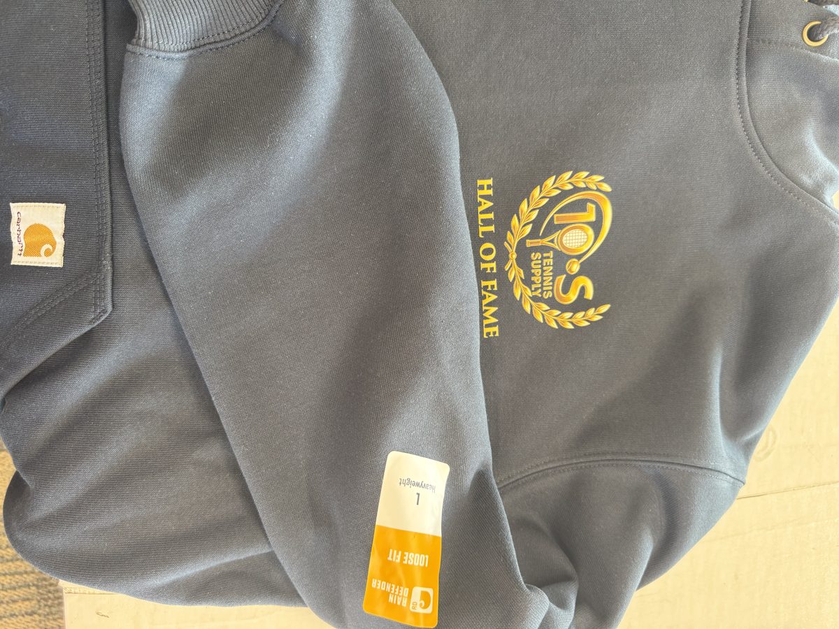 TOS Tennis Supply Hall of Fame logo embroidered in gold on a navy Carhartt heavyweight hoodie